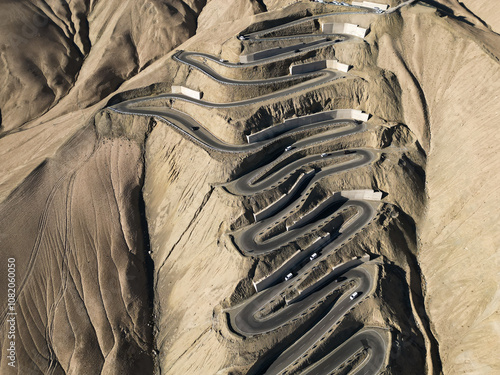 Scenic view of the winding hill road named Pan Long Ancient Road in Tashkurgan, Xinjiang, China. photo