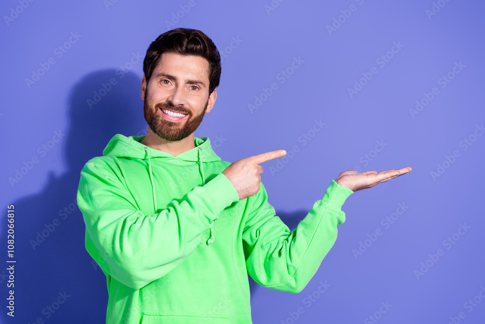 Naklejka premium Photo of mature age funky man wearing bright green hoodie sportswear holding hand black friday discount isolated on violet color background