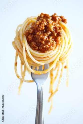 A close-up shot of a fork filled with spaghetti and tomato sauce, perfect for food and cooking images photo