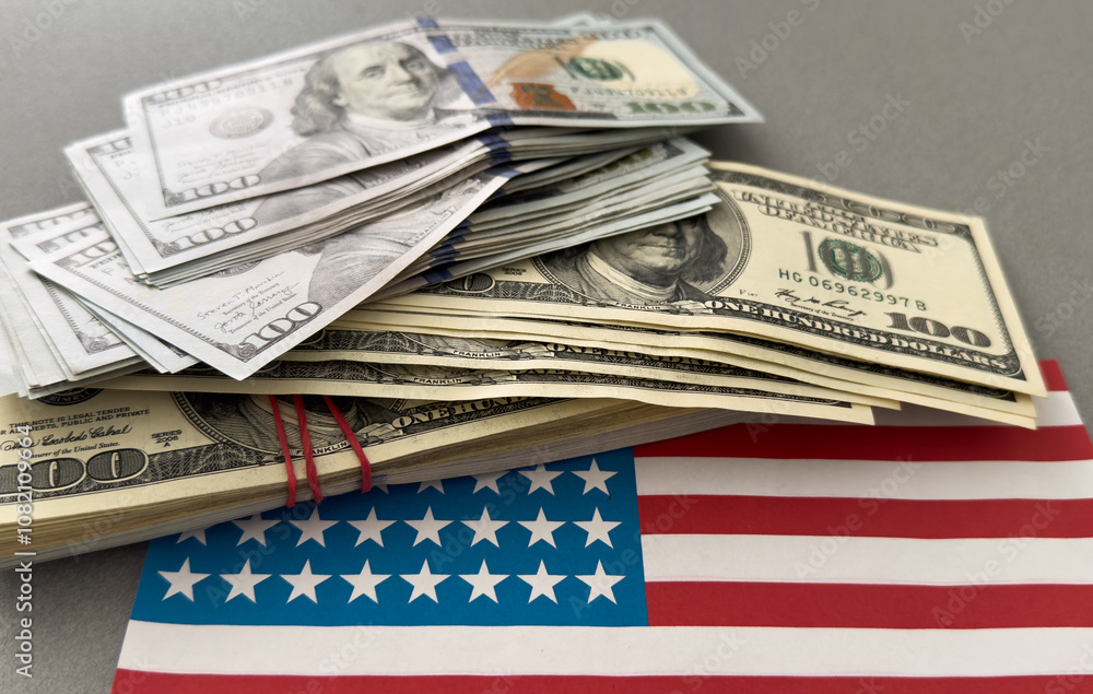 One hundred dollars banknotes on flag background One hundred dollars banknotes on flag background