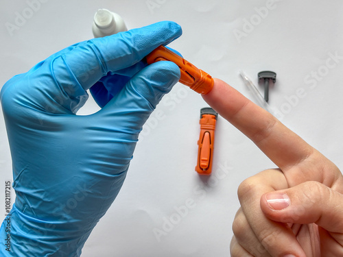 Papier peint medical professional using a lancet to collect a blood sample from the fingertip