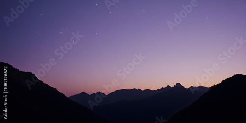 Silhouette of mountain peaks under a gradient twilight sky with stars twinkling in the background creating a serene and tranquil atmosphere