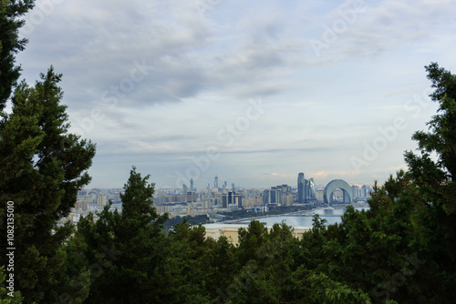 view of the city from above with modern architecture and old reflected in water of caspian sea baku city bay photo