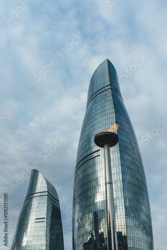 View of baku city bay with flame towers modern architecture on top of hill in blue sky