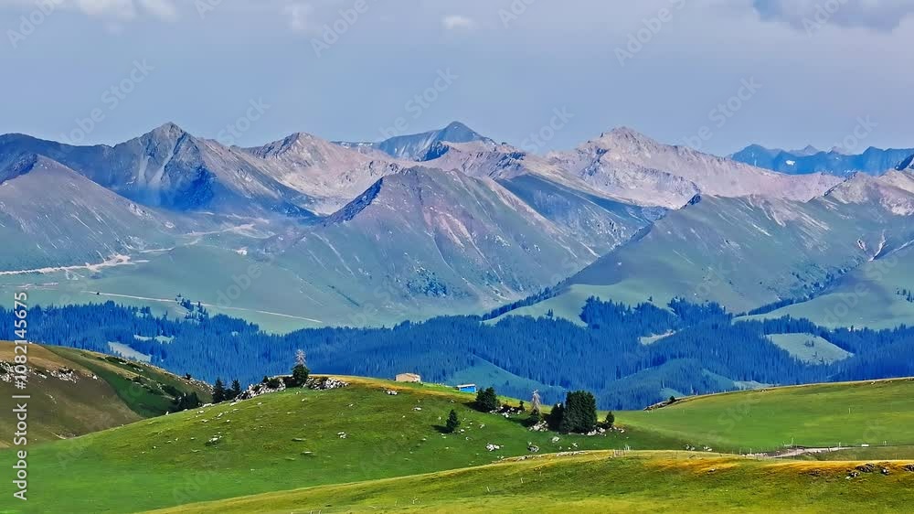 Green grass and forest with mountain natural landscape in Kalajun grassland, Xinjiang. Kalajun Grassland is one of the most famous grasslands in China. Green grass and forest with mountain natural landscape in Kalajun grassland, Xinjiang. Kalajun Grassland is one of the most famous grasslands in China.