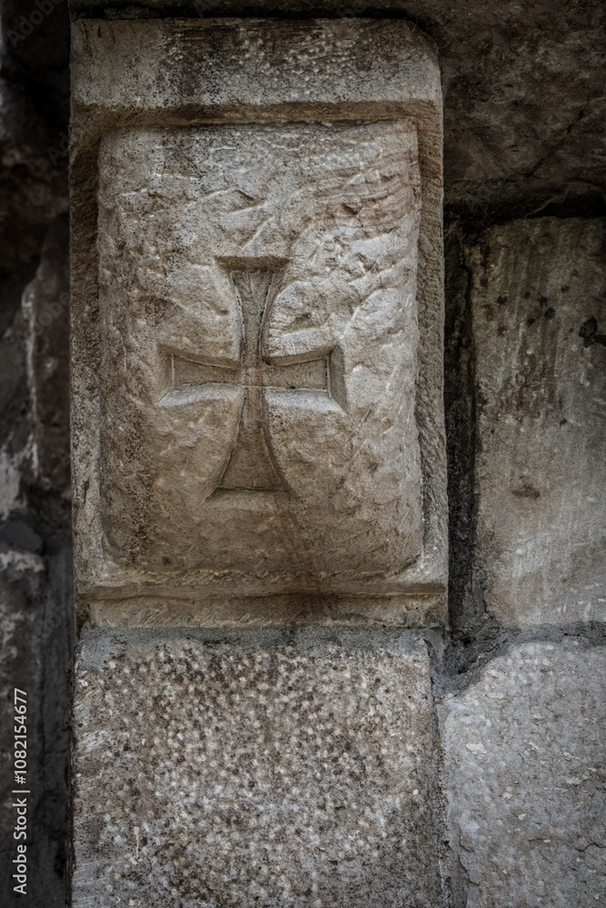 Templar cross, Romanesque carving, on Church of San Cipriano de Bolmir, Romanesque temple from the 12th century, Bolmir village, Campoo de Enmedio, Cantabria, Spain Templar cross, Romanesque carving, on Church of San Cipriano de Bolmir, Romanesque temple from the 12th century, Bolmir village, Campoo de Enmedio, Cantabria, Spain