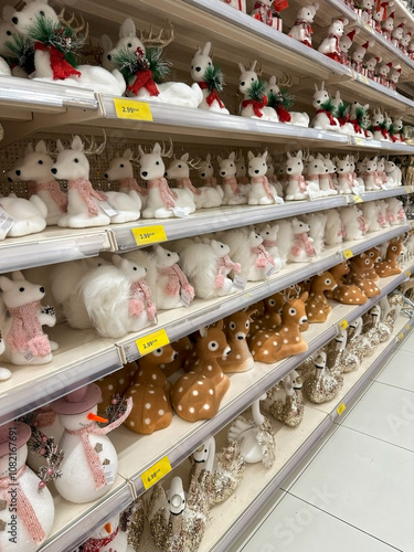 Wallpaper Mural A retail display of Christmas-themed decorations including wooden ornaments, reindeer, Christmas trees, and festive signs. Various holiday phrases and designs are featured on the shelf. Torontodigital.ca