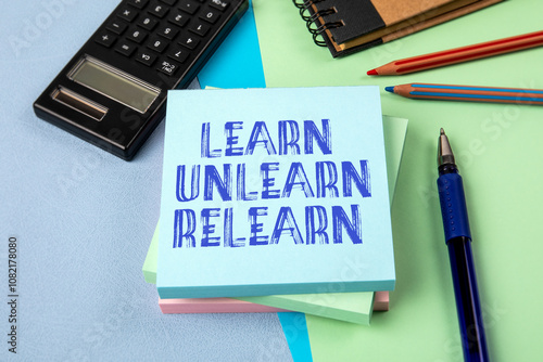 Learn Unlearn Relearn Concept. Notepad with text on office table