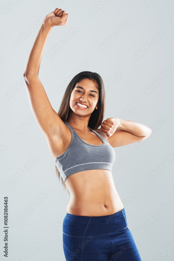 Studio, woman and portrait with fist for fitness, celebration and achievement for wellness target. Female person, happiness and excited with hands pump for exercise goal, progress or gray background Studio, woman and portrait with fist for fitness, celebration and achievement for wellness target. Female person, happiness and excited with hands pump for exercise goal, progress or gray background