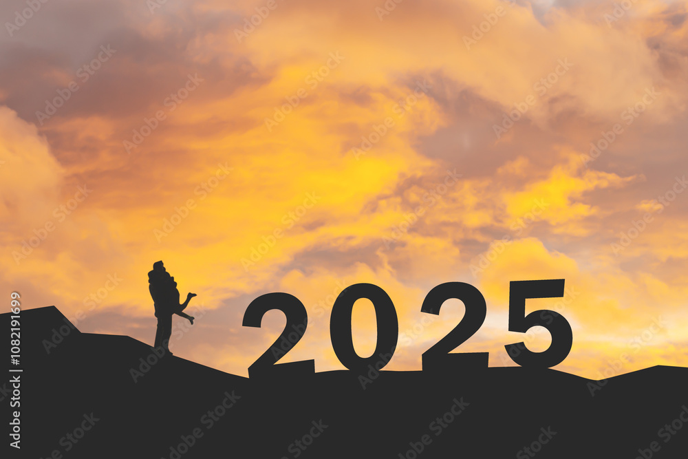 silhouette of miniature couple with text 2025 over blurred sky background silhouette of miniature couple with text 2025 over blurred sky background