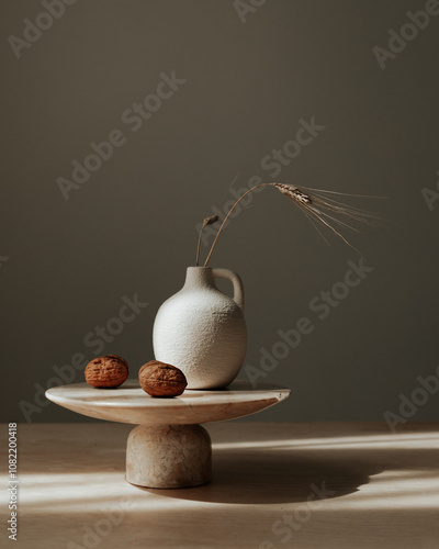 Still life composition featuring a classic milk or water jug, a cluster of walnuts, and a wheat stem arranged on a neutral background.  photo