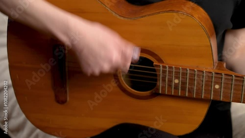 Woman playing classical acoustic guitar with strings. Female strumming classical guitar with strings. Lady playing stringed acoustic guitar
