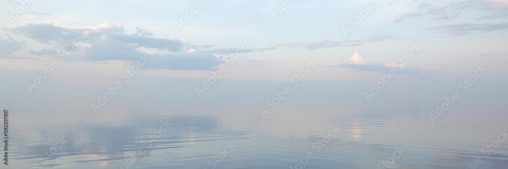 Fototapeta premium Serene vertical shot of still water reflecting the sky, aquatic, vertical