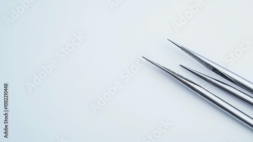 Tweezers on a white background, top view, sharp details