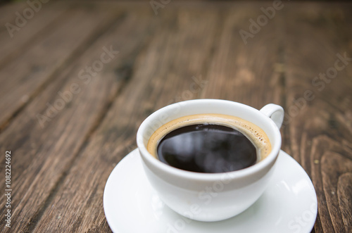 Cup of aromatic coffee on wooden table. Space for text