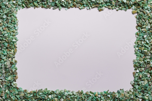 An unusual frame made of a scattering of green pebbles with copy space for text or images