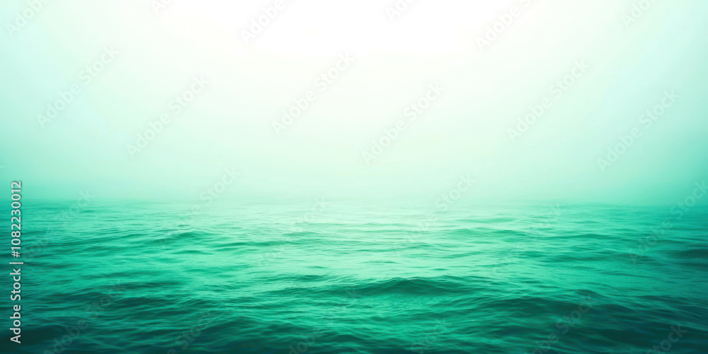 A calm, clear ocean with a light blue sky in the background A calm, clear ocean with a light blue sky in the background