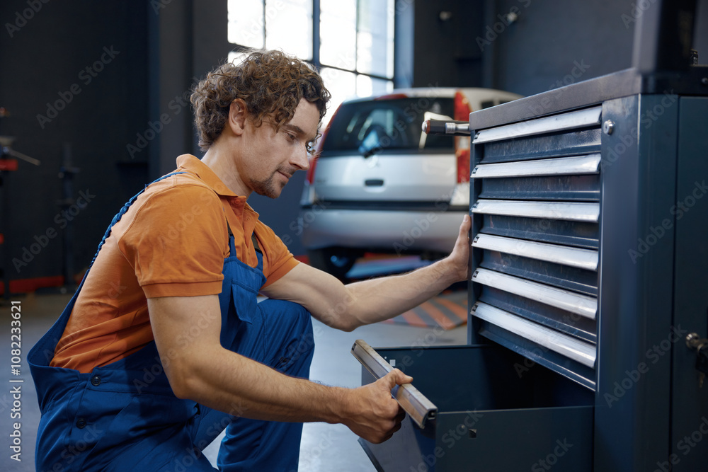 Male mechanic taking tools for work Male mechanic taking tools for work