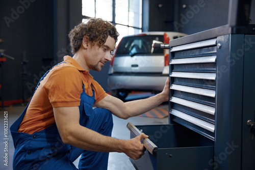 Male mechanic taking tools for work