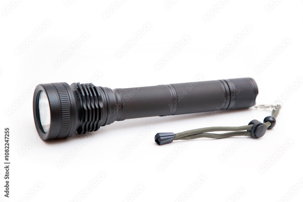 black flashlight with a string on a white background black flashlight with a string on a white background