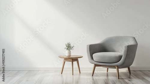 Cozy gray armchair beside a modern wooden table with greenery, set in a bright, minimalist room.