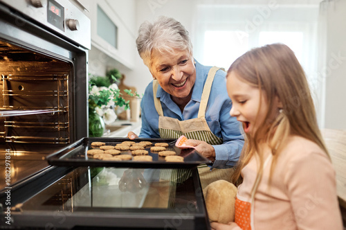 Obraz na plátně grandmother oven kitchen granddaughter baking family child bonding homemade cook