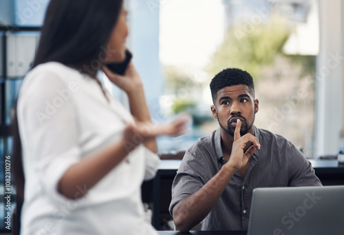 Quiet, business man and phone call in office for distraction, noise and colleague for communication. Coworking, employees and woman with mobile for networking, hand gesture and shush for silence