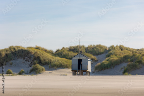 A wooden shelter on high stilts that stands on the North Sea beach (De Drenkelingenhuisje) The Dutch Wadden Sea island Terschelling, Municipality and an island in the northern, Friesland, Netherlands. photo