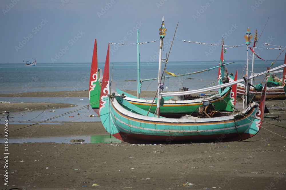 Traditional Fishing Boats Resting on a Sandy Shore Traditional Fishing Boats Resting on a Sandy Shore
