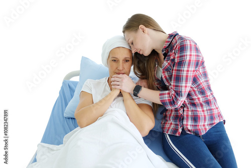 Smiling Caucasian daughter with elderly mother lying on a hospital bed and holding hand together after chemotherapy in hospital. she is suffering from cancer or Leukemia patient. Clip art and element