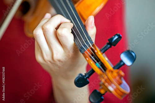 play the violin with the left hand. Correct positioning of the hand and fingers on a musical instrument