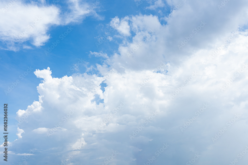 Beautiful fluffy white clouds drift across a bright blue summer sky Beautiful fluffy white clouds drift across a bright blue summer sky