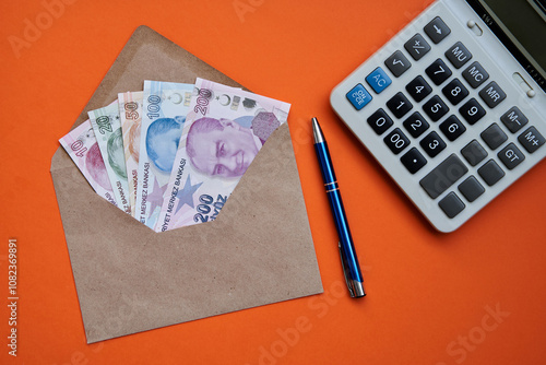 Turkish lira. Sequential in envelope. 
(On orange textured fabric background)