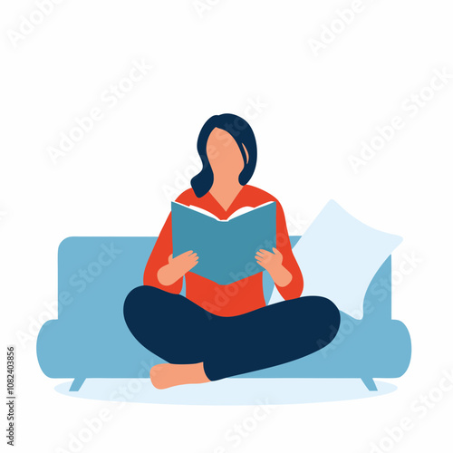 Woman reading a book comfortably on a blue sofa at home
