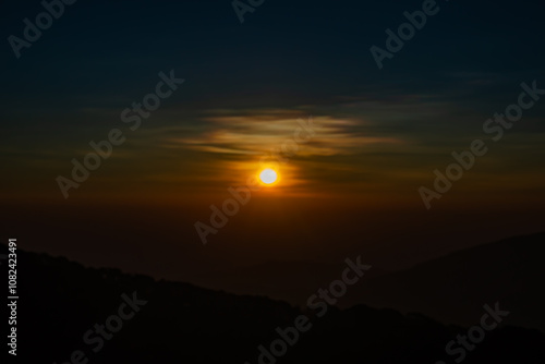 The beautiful sunrise at Doi intanon national park, Chiang Mai in the morning.Sun is rising from the hill to shy with beautiful yellow orange light. photo