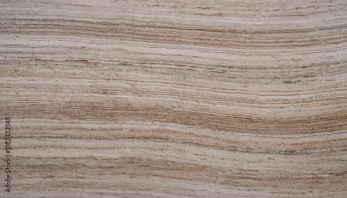 A close-up of natural beige stone surface with horizontal, layered texture, resembling sedimentary rock.