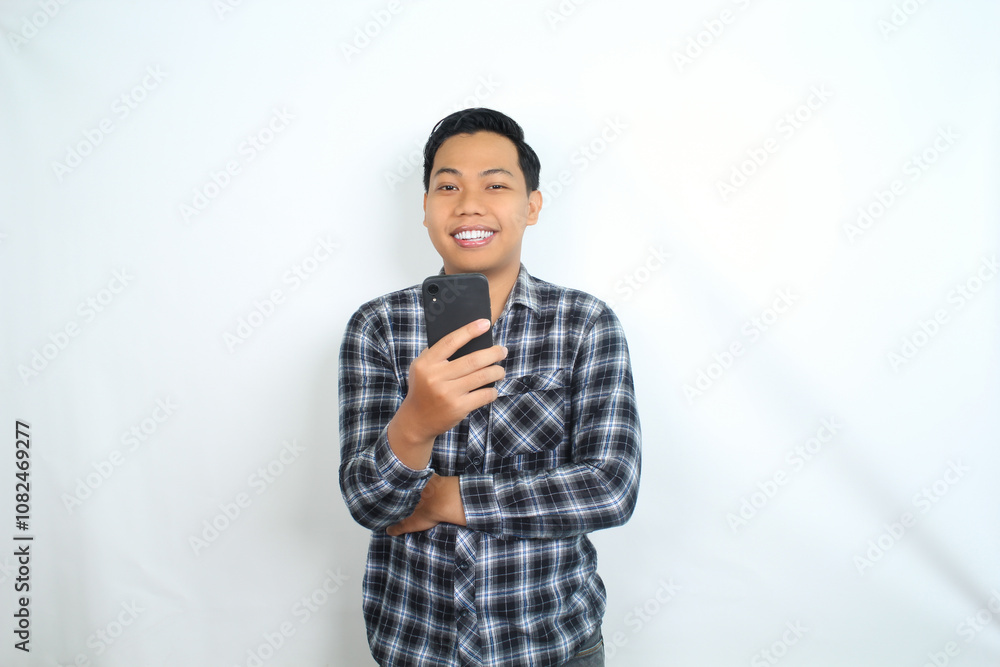 portrait of smiling asian man using smartphone wearing casual shirt isolated on white portrait of smiling asian man using smartphone wearing casual shirt isolated on white