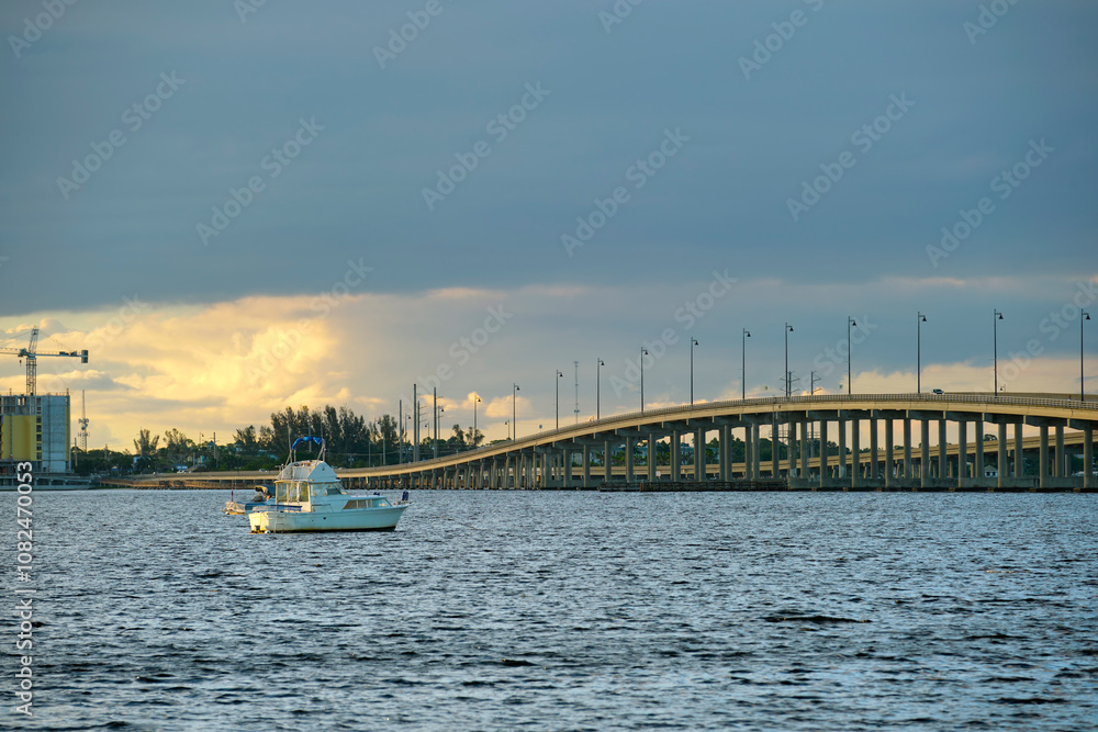 Barron Collier Bridge and Gilchrist Bridge in Florida with moving traffic. Transportation infrastructure in Charlotte County connecting Punta Gorda and Port Charlotte over Peace River Barron Collier Bridge and Gilchrist Bridge in Florida with moving traffic. Transportation infrastructure in Charlotte County connecting Punta Gorda and Port Charlotte over Peace River