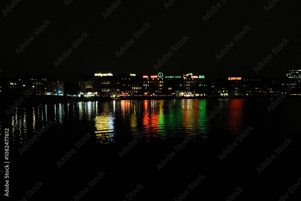 Nightview of Sortedam lake (Sortedams sø) and neon light advertisement billboards in Copenhagen, Denmark. Nightview of Sortedam lake (Sortedams sø) and neon light advertisement billboards in Copenhagen, Denmark.