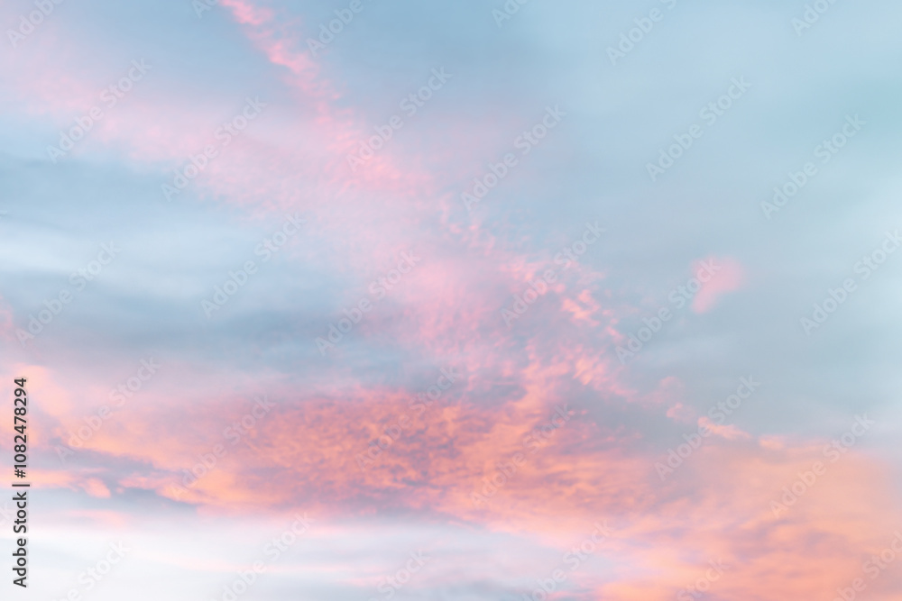 Obraz premium A beautiful sky tinted by the sun leaving vibrant shades of gold, pink, blue and multicolored. Clouds in the twilight evening and morning sky. Cloudy sky background in the evening, and during the day.