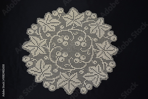 Round napkin with grape leaves, crocheted using fillet knitting technique