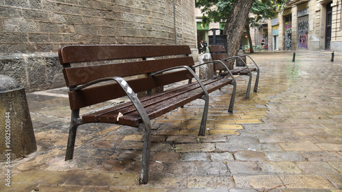 Obraz na płótnie an old bench in the streets of Barcelona Spain w salonie