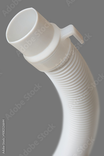 close-up of flexible drain hose or pipe of washing machine isolated gray background, end of plastic or pvc flexi pipe used in plumbing system for water supply and drainage photo