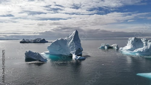 Huge icebergs floating in the water off the coast of Greenland, close to Oqaatsut near Ilulissat. Aerial view.