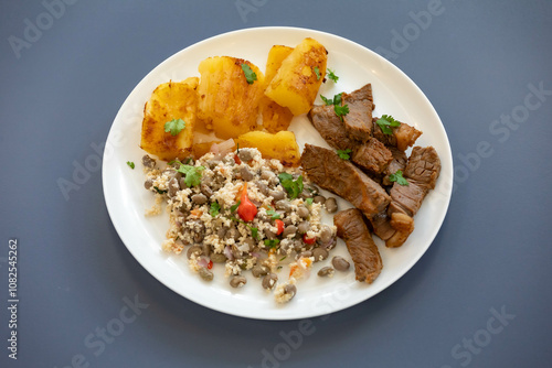 Traditional rustic tropical Brazilian dish, sun-dried beef with green beans, cassava, biquinho pepper. Creative rustic photography photo