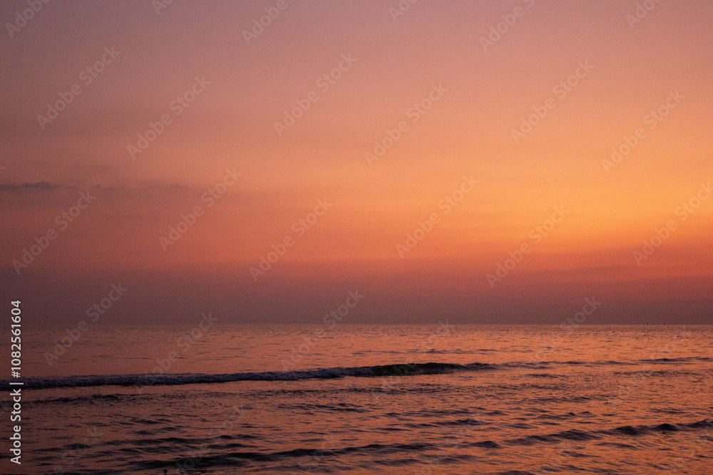 a purple and orange sky with a sunset in the background