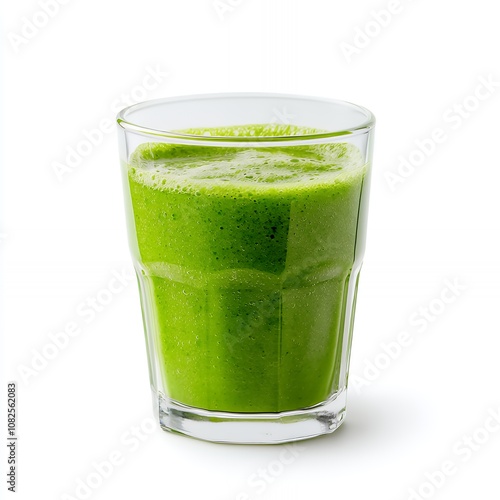 A glass of green smoothie on a white background.