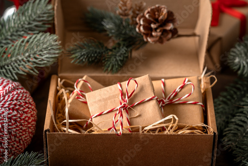 Obraz na płótnie Christmas or New Year's gifts in craft packaging in a gift box on a festive table close-up w salonie