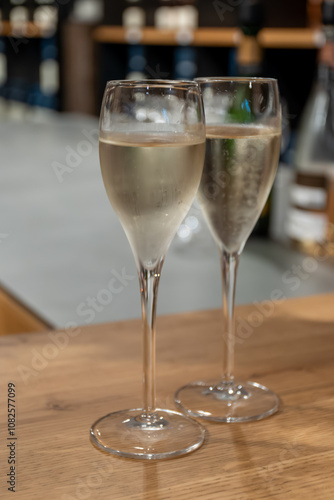 Tasting sparkling white wine, traditional champagne method making of cremant in caves on Moselle river valley in Luxembourg, wine tour and visiting caves photo