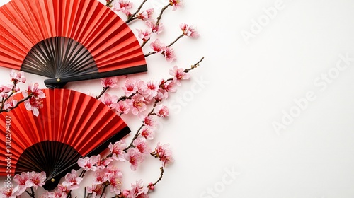 Festive arrangement for Lunar New Year, featuring red fans, and pink sakura flowers. Top view on a white background with ample space for custom messages or advertisements.